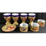 A set of four Durley Porcelain egg cups, by James Skerrett, signed, painted with ripe peaches and