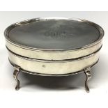 An Edwardian silver oval dressing table box, cabriole legs, 10cm wide, London 1908