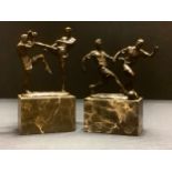 A modern bronzed group, of two footballers, marble base, 23cm high; another, kick boxers, 26cm