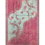 Textiles - a Paisley shawl, brightly embroidered in shades of pink, orange, ochre and green, approx.