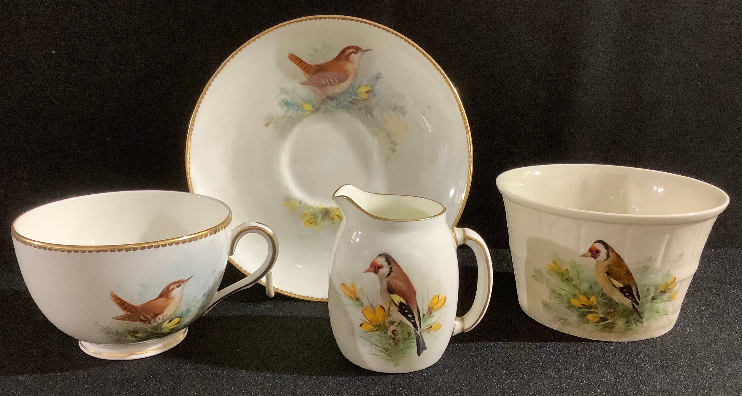 A Royal Worcester tea cup and saucer, by W Powell, signed, painted with a wren, printed mark in