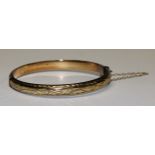 A 9ct gold hinged bangle, 8.8g