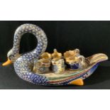 A French Henriot Quimper novelty swan egg stand with six eggcups, painted in bright colours, 40cm