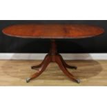 A Regency design gilt metal mounted mahogany rounded rectangular pedestal dining table,