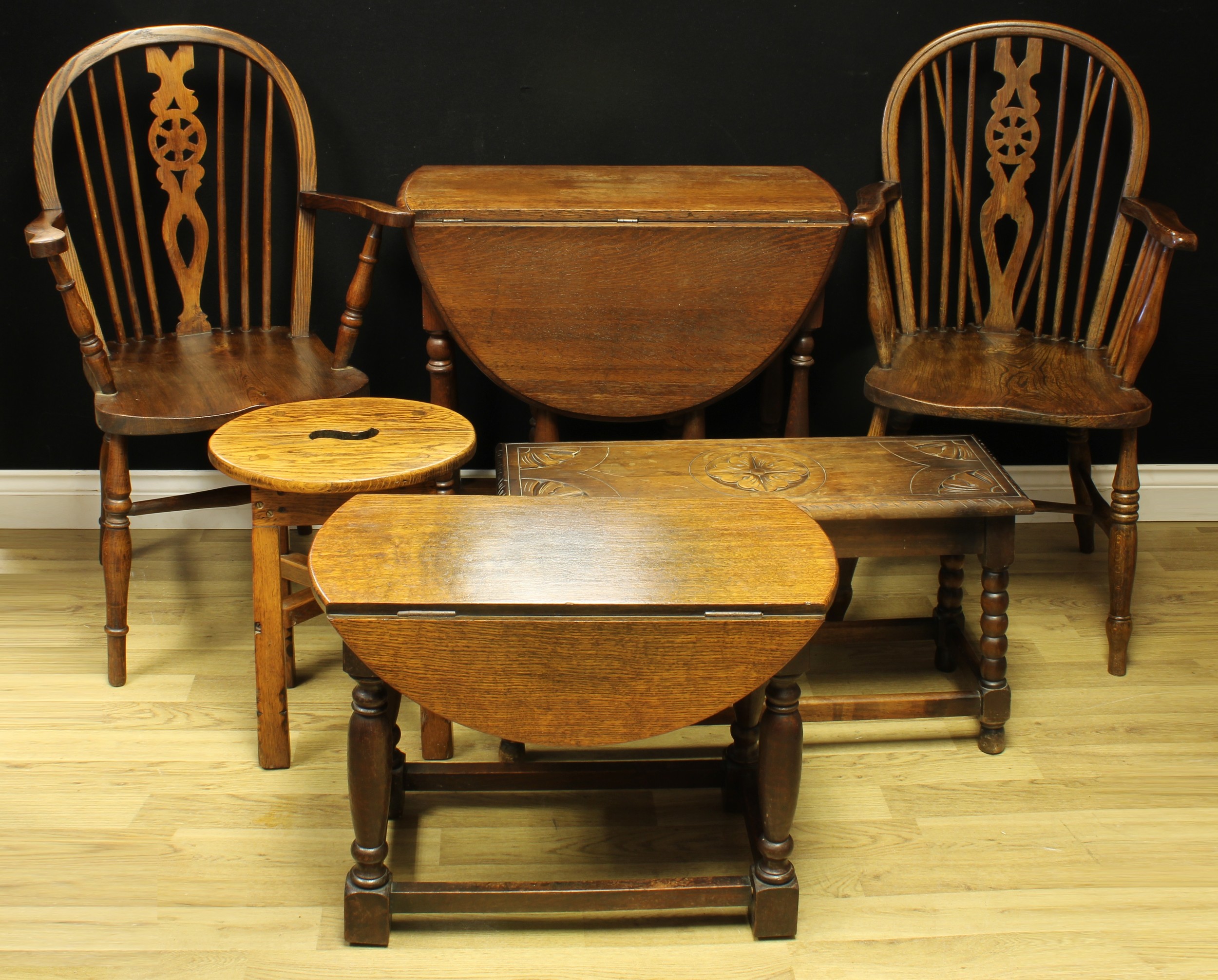 A near pair of wheelback 'Windsor' elbow chairs, 100cm high, 54cm wide, the seat 37cm wide and