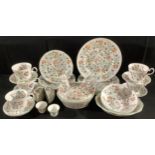 A Staffordshire part dinner service, printed with colourful flowers, plates, cups and saucers, apple