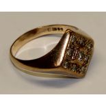 A 9ct gold gent's signet ring, the central diamond surrounded by eight smaller stones, 6.9g