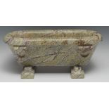 A Grand Tour style marbled stone cistern or trough, carved after the Roman with rings, 41cm wide