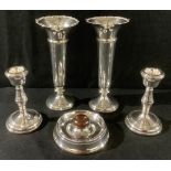 A pair of silver specimen vases, 15cm high, Birmingham 1916; a pair of boudoir candlesticks,