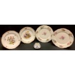 A pair of Meissen shaped circular dessert plates, painted with colourful birds within a gilt border,