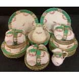 A 19th century Staffordshire tea service, comprising cake plate, side plates, cups and saucers, etc