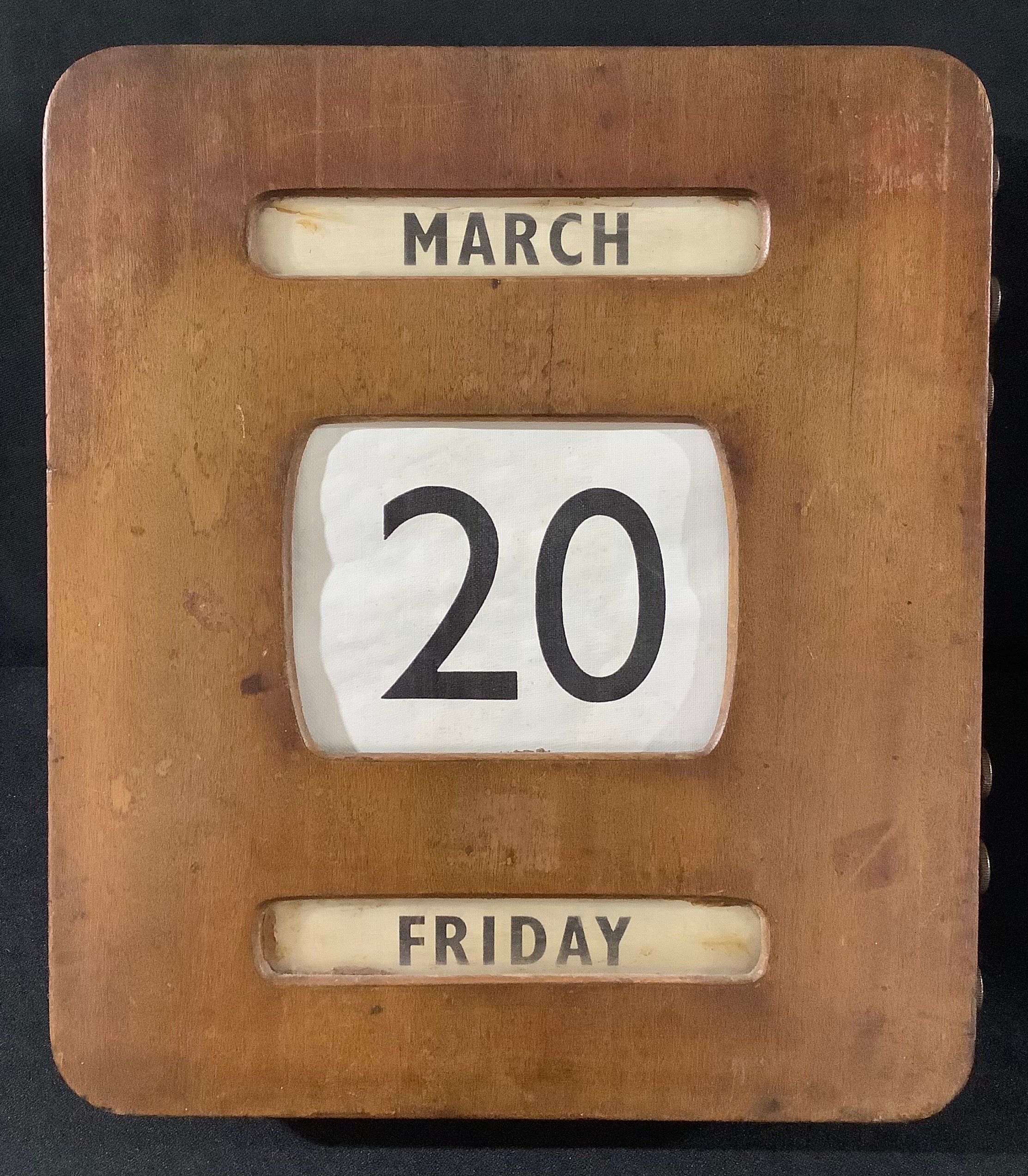 An Art Deco rounded rectangular wall-hanging perpetual calendar, 30.5cm x 27cm, c. 1930