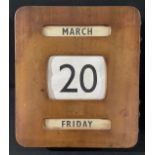 An Art Deco rounded rectangular wall-hanging perpetual calendar, 30.5cm x 27cm, c. 1930