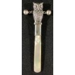 A silver novelty baby's rattle, as an owl