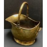 A brass swing handled helmet shaped coal scuttle, 45cm high overall