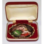 An Italian late 19th century oval painted porcelain brooch, Madonna and Child, mounted in a