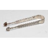 A pair of unusual George III silver sugar bows, bright-cut in imitation of cut-steel, 13.5cm long,