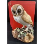 A Royal Crown Derby model, of a Barn Owl, naturalistically modelled, 25cm high, printed marks, boxed