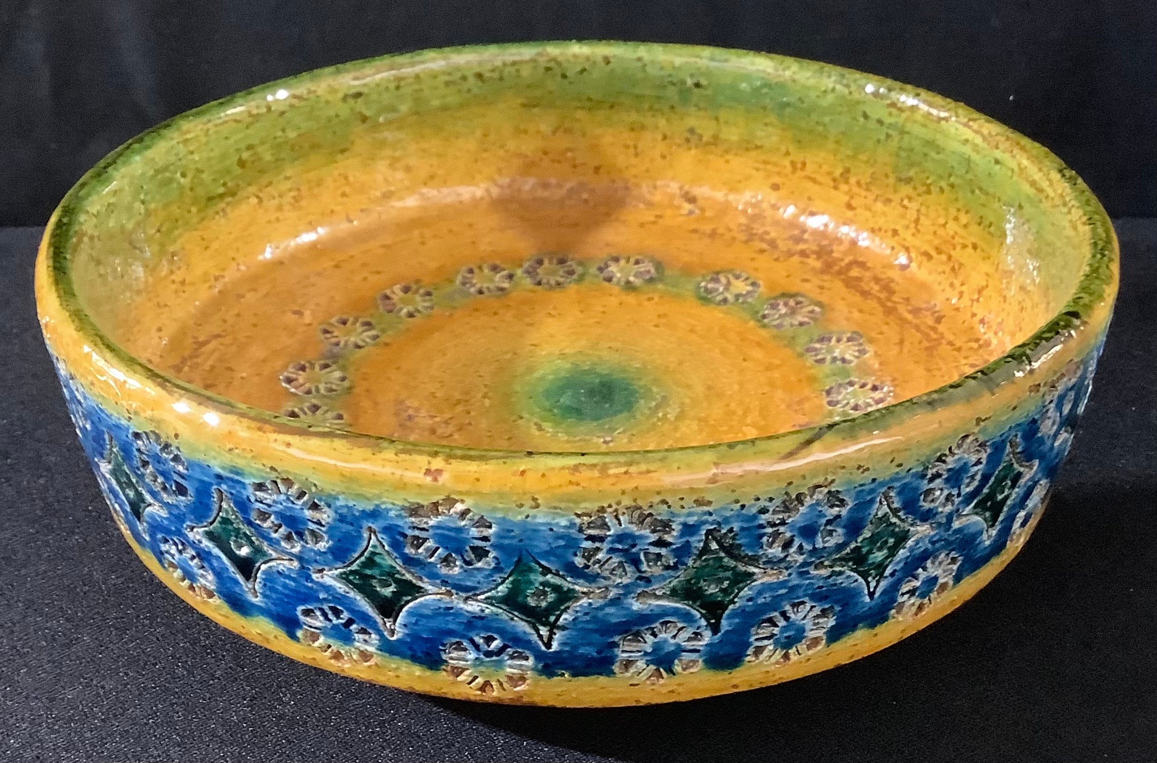 An Italian stoneware art pottery bowl by Nuovo Rinascimento, impressed and glazed in shades of