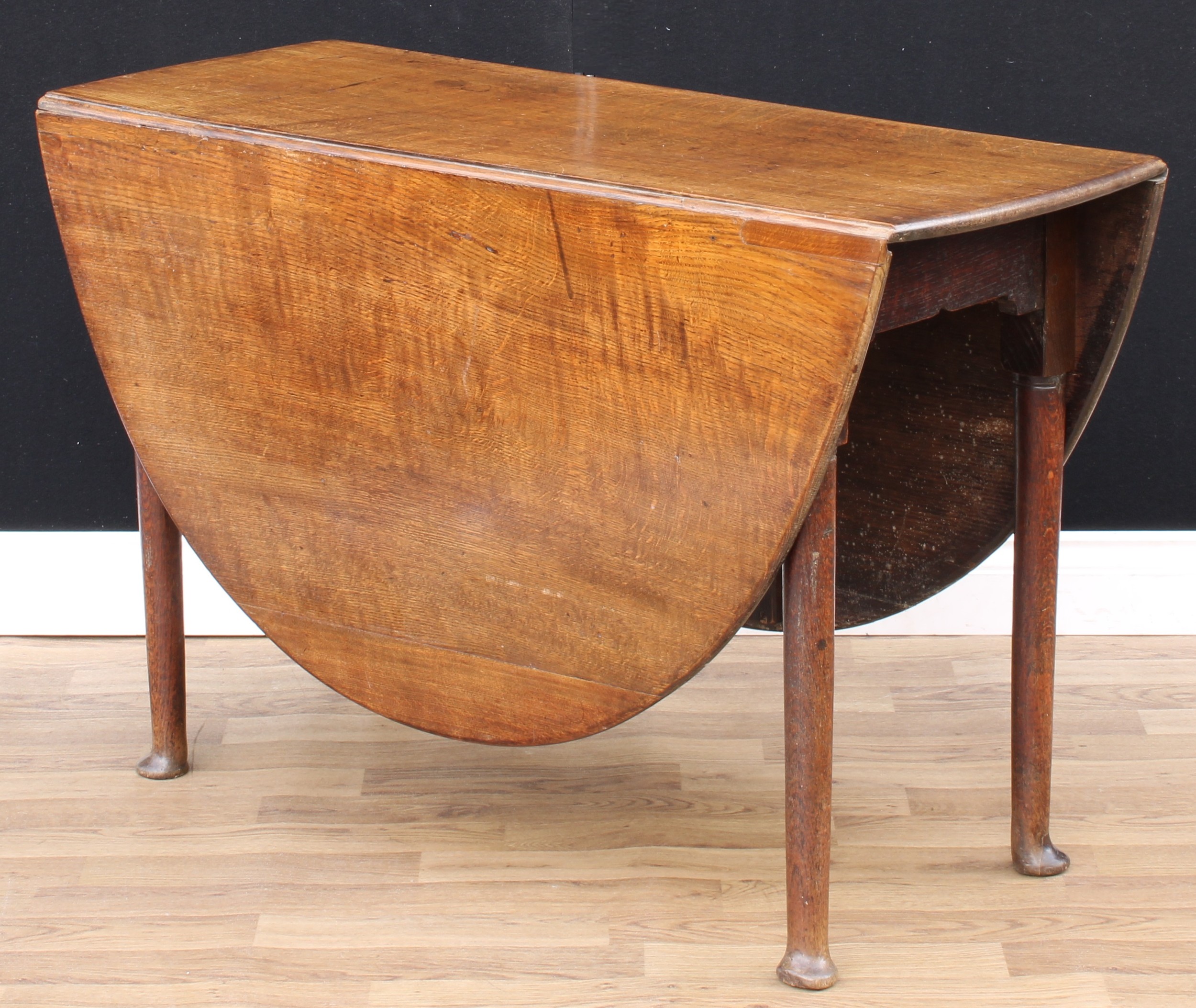 A 'George II' oak gateleg dining table, oval top with fall leaves, cylindrical legs, pad feet, - Image 2 of 3