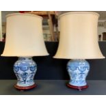 A pair of reproduction Chinese blue and white ginger jar light fittings, , 44cm high, cream shades