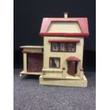 A 1930s two storey Dolls House, red roof, cream exterior, fitted with assorted Dol-Toi, Britains and