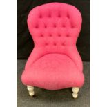 A Stuart Jones upholstered bedroom chair, floral pink upholstery, button back, turned legs, brass