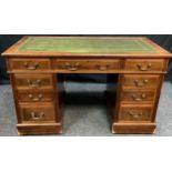 A late Victorian oak twin pedestal desk, rectangular top above three frieze drawers, three further