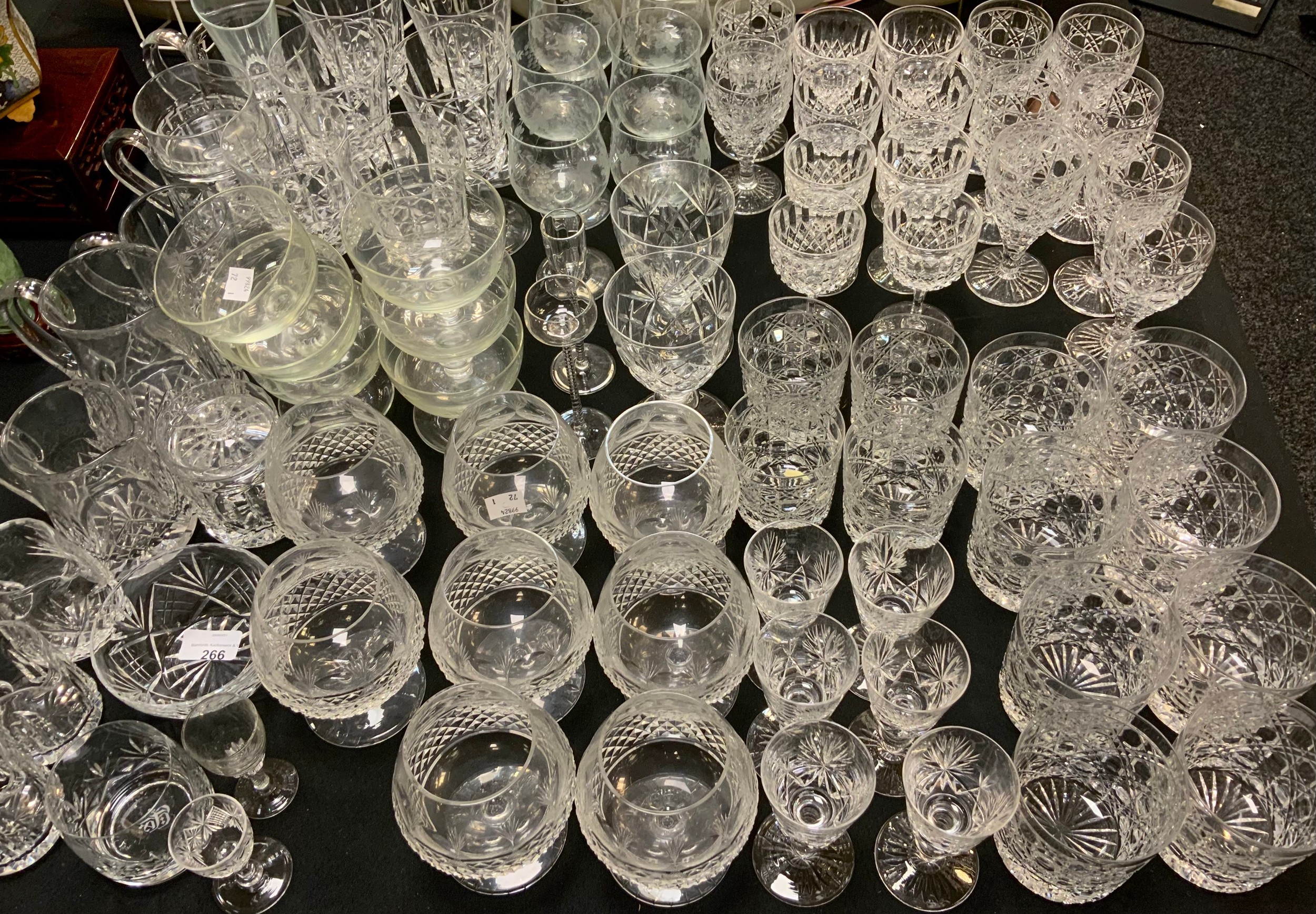 A set of eight cut glass brandy glasses; eight large whisky tumblers; others smaller; wine
