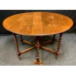 An early 20th century oak Sutherland table, oval top, barley twist legs, casters, 76cm high, 120cm