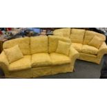 A pair of three seat sofas, golden yellow floral upholstery, each measuring 232cm wide x 91cm