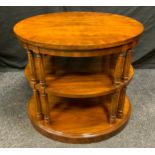 A 20th century, three-tier, mahogany oval centre table/stand, turned and reeded supports, 59cm tall.