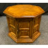 A 20th century elm octagonal pedestal cupboard, 55cm high, 68cm wide.