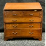 An Apprentice Cabinet Maker's miniature mahogany Bureau; fall front enclosing four short drawers and