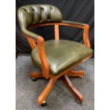 A 20th century faux green leather swivel office chair