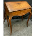 A late Victorian walnut bureau de dame, inpaid with griffins and acanthus scrolls, cabriole legs,