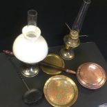 A copper warming pan; oil lamps; Indian brass charger etc