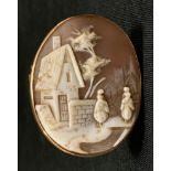 A 9ct gold framed oval cameo brooch, figure and cottage landscape, stamped 9ct, 9.1g gross