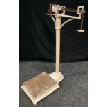 A Set of early 20th century floor standing cast iron weighing scales, with weights.