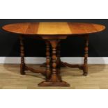 A 17th century style oak gateleg dining table, oval top with fall leaves, turned supports, trestle