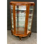 A 1950/60s walnut veneered serpentine display cabinet, 118cm x 84cm.