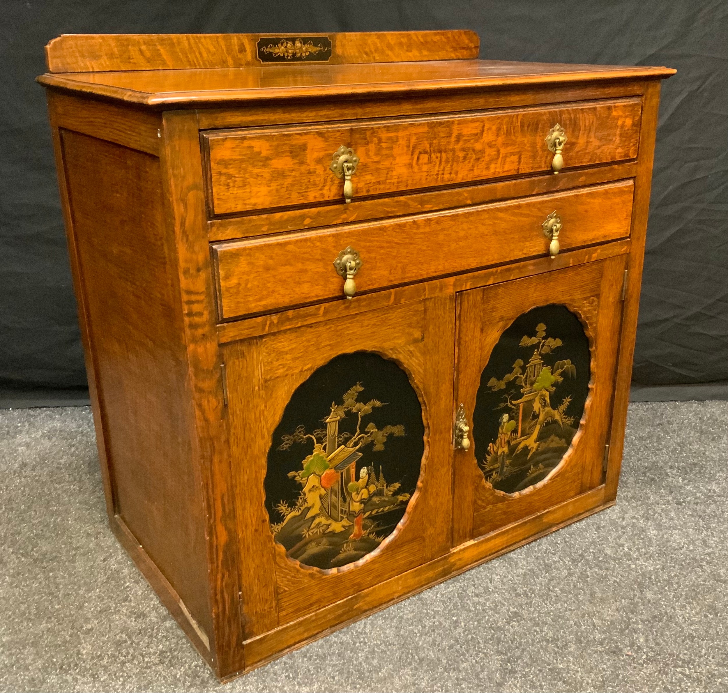 An Early 20th century oak cabinet chest, two long drawers above a pair of cabinet doors with