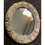 A Sampson Hancock Derby oval mirror, encrusted with chrysanthemums and other foliage, 32cm high, c.