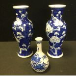 A pair of late 19th century Chinese blue and white urn vases, decorated with tradition blossoms,