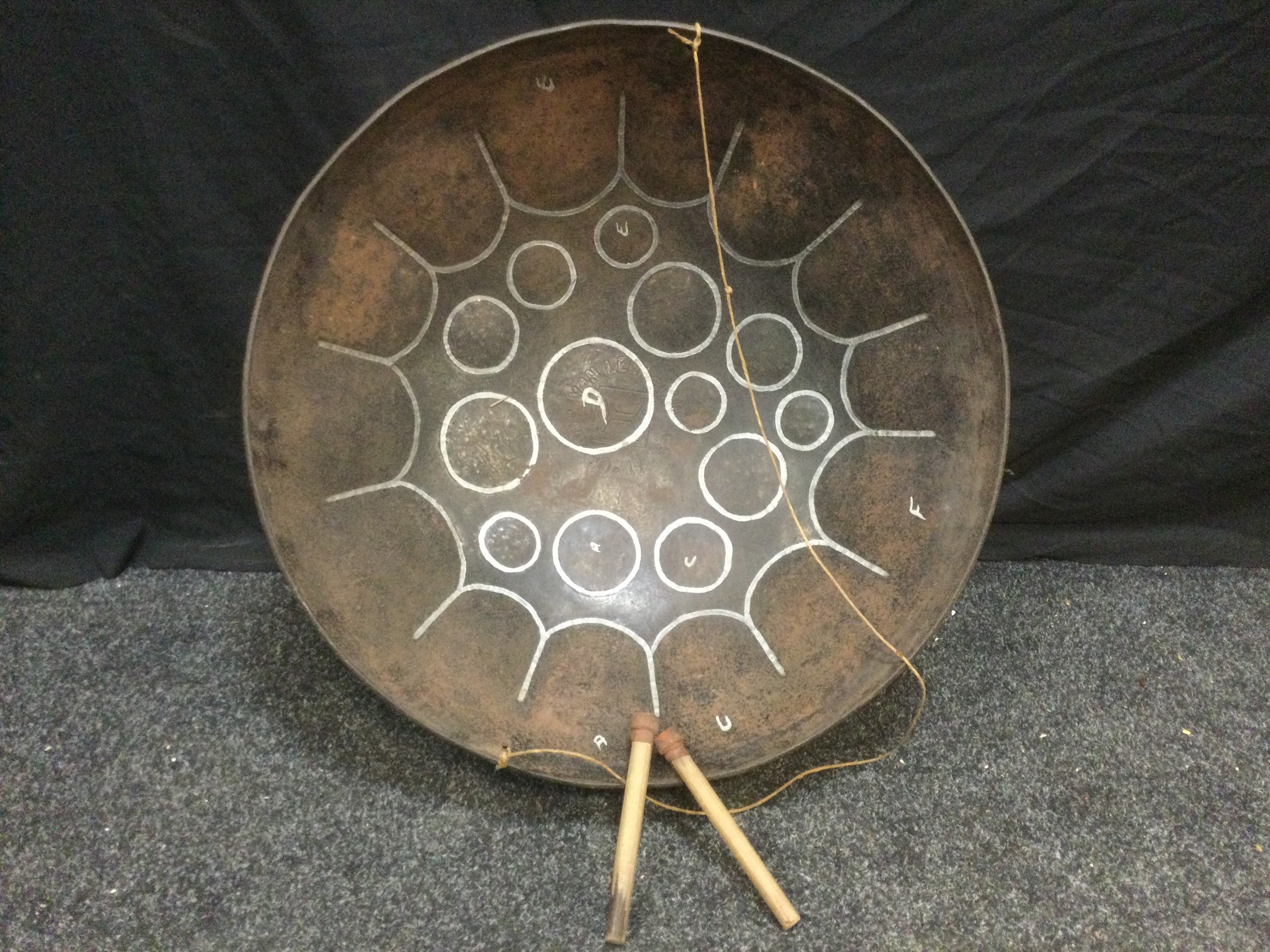 A Guyana steel drum, circular body, shaped and painted note marked top, 57.5cm diameter.