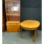An Ercol style bookcase cabinet, a pair of glazed doors enclosing a shelf, the projecting base