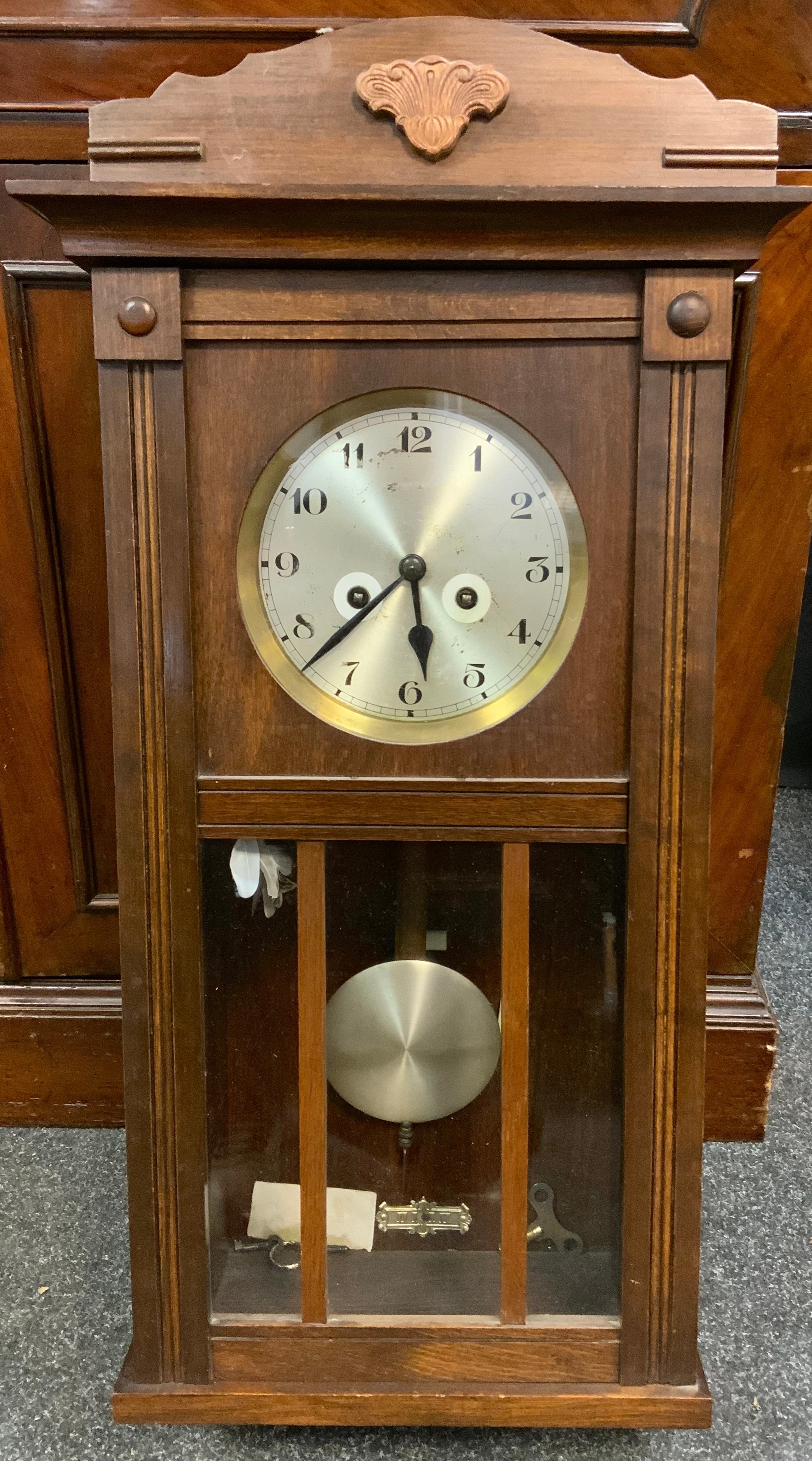 A 20th century oak wall clock, 73cm long.