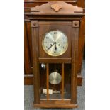 A 20th century oak wall clock, 73cm long.