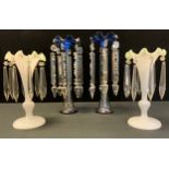 A pair of 19th century blue and clear glass table lustres, wavy flared top suspending six cut