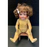 A German Huebach and Koppesledorf bisque head socket doll, sleeping blue eyes, open mouth, brown